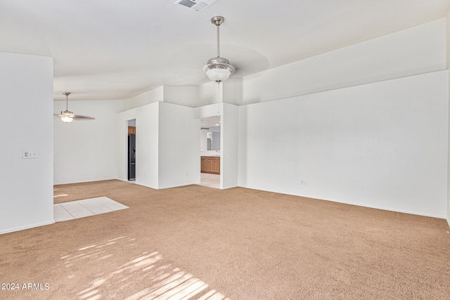 unfurnished living room with ceiling fan and light colored carpet