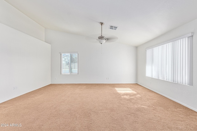 carpeted empty room featuring ceiling fan and lofted ceiling