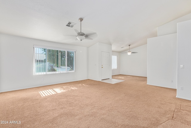 interior space with ceiling fan, light carpet, and lofted ceiling