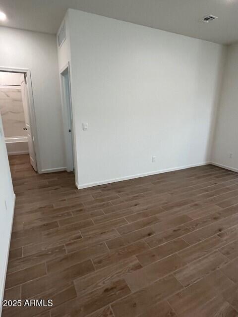 empty room featuring dark hardwood / wood-style flooring