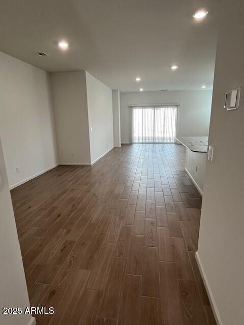 unfurnished room featuring dark wood-type flooring