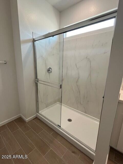 bathroom featuring a shower with shower door