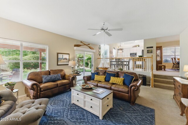 living area with dark carpet and ceiling fan