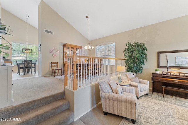 staircase featuring visible vents, baseboards, high vaulted ceiling, a notable chandelier, and carpet