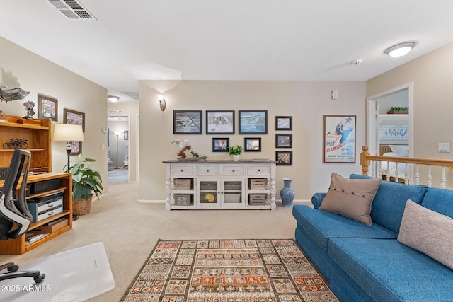 living area with baseboards, visible vents, and carpet