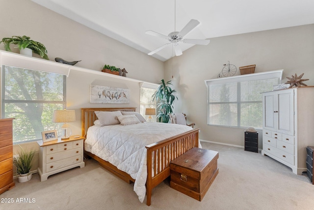 carpeted bedroom with baseboards, ceiling fan, and vaulted ceiling