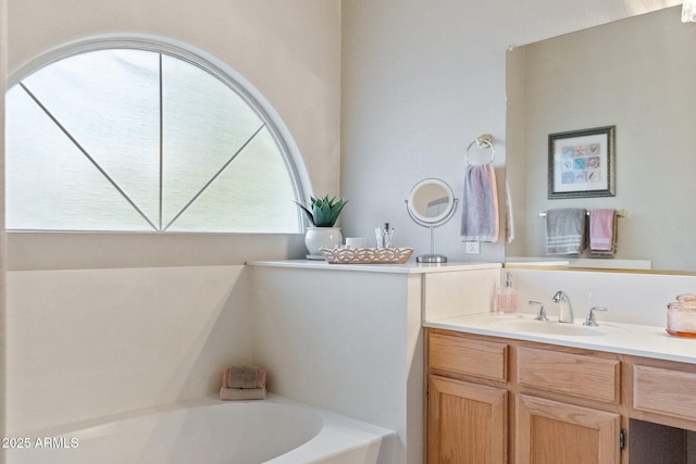 bathroom with vanity and a garden tub