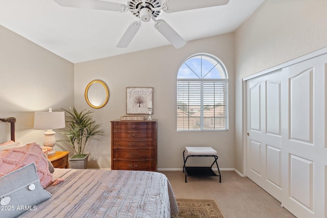 bedroom featuring a closet, lofted ceiling, baseboards, ceiling fan, and carpet