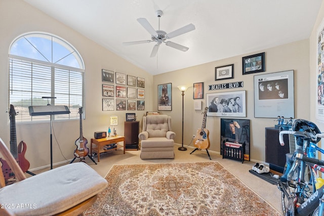 living area with carpet floors, a ceiling fan, baseboards, and lofted ceiling