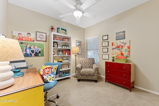 carpeted home office featuring baseboards and a ceiling fan