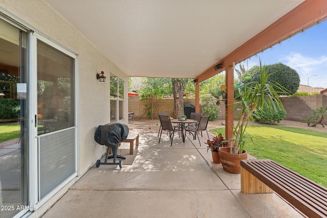 view of patio with a fenced backyard and outdoor dining area