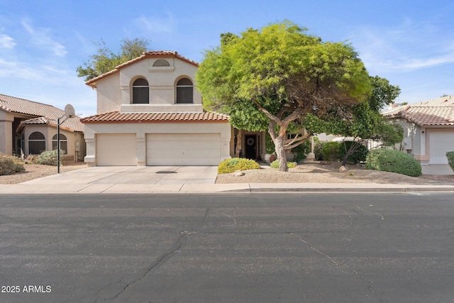 mediterranean / spanish house with an attached garage, stucco siding, and driveway