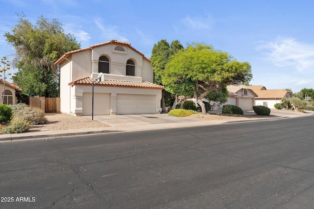 mediterranean / spanish-style house with fence, a tile roof, a garage, stucco siding, and driveway