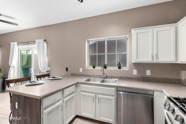 kitchen featuring light tile patterned flooring, white cabinetry, sink, and appliances with stainless steel finishes