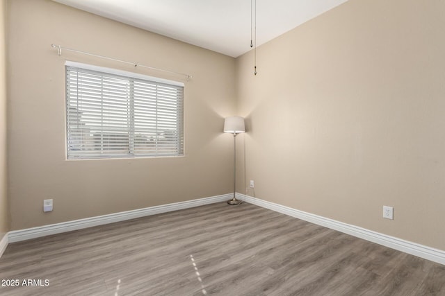 spare room with hardwood / wood-style floors