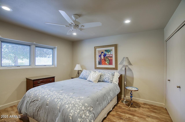 bedroom featuring recessed lighting, a closet, baseboards, and wood finished floors