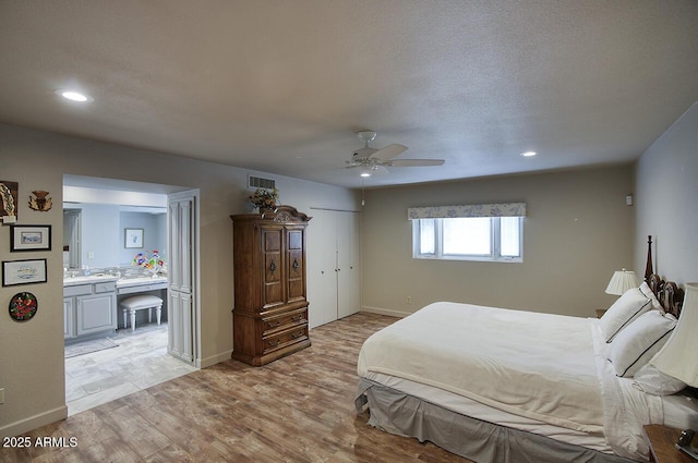 bedroom featuring light wood finished floors, baseboards, visible vents, and recessed lighting