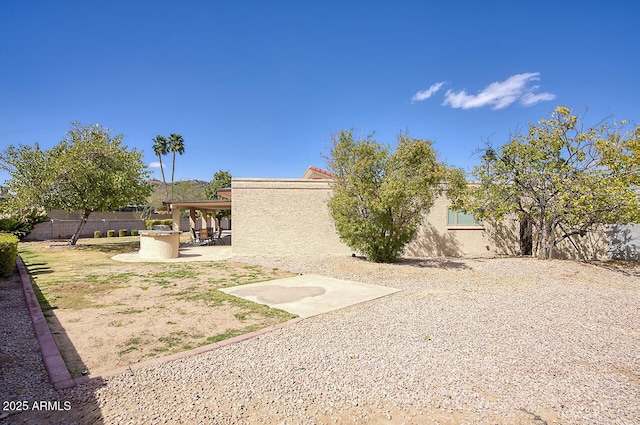 back of property with a patio, fence, and stucco siding