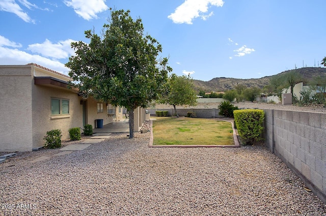 view of yard featuring a patio, fence private yard, and a mountain view