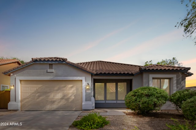 mediterranean / spanish-style house with a garage