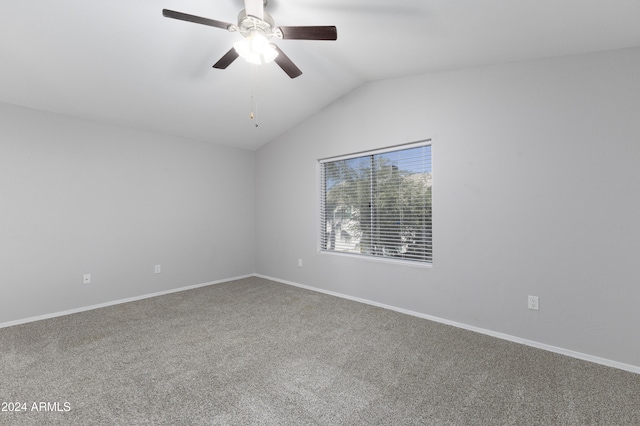 carpeted spare room with ceiling fan and lofted ceiling