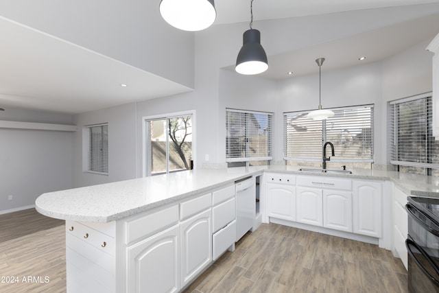 kitchen featuring white dishwasher, white cabinetry, kitchen peninsula, and sink