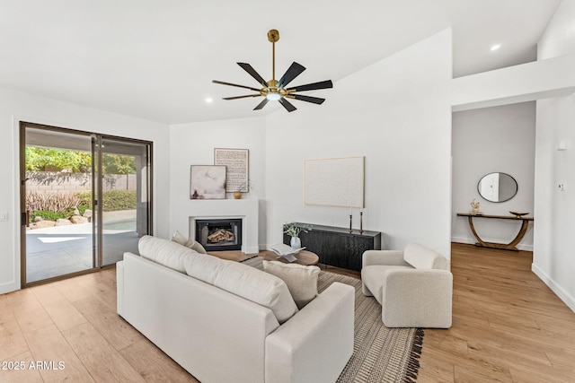 living room with ceiling fan and light wood-type flooring