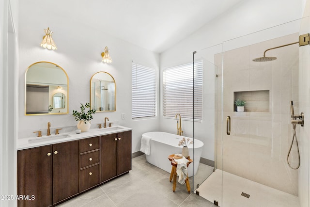 bathroom featuring tile patterned floors, vanity, independent shower and bath, and vaulted ceiling