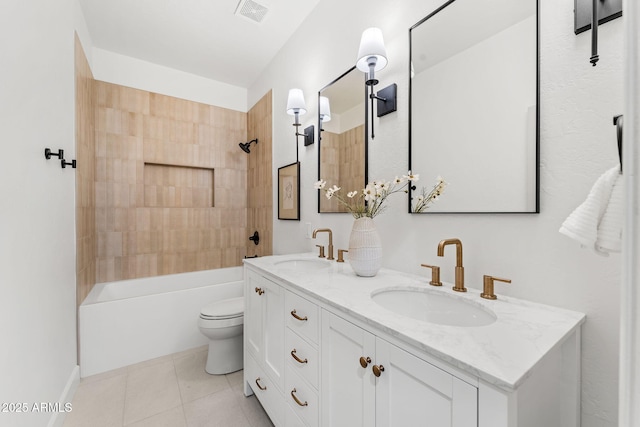 full bathroom with vanity, tiled shower / bath combo, tile patterned floors, and toilet