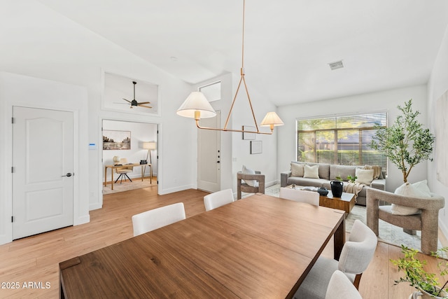 dining room with vaulted ceiling, ceiling fan, and light wood-type flooring