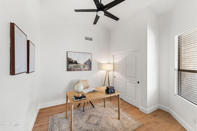 office space with hardwood / wood-style flooring, ceiling fan, and high vaulted ceiling