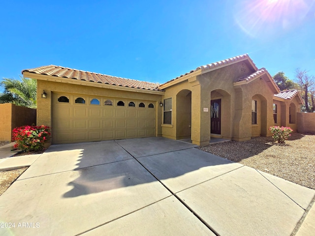 mediterranean / spanish-style house featuring a garage