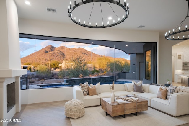 living room with light hardwood / wood-style floors and a mountain view