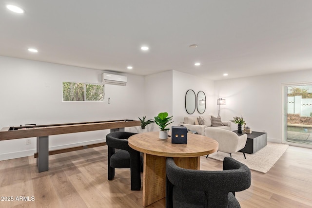 dining space featuring recessed lighting, plenty of natural light, light wood-style floors, and a wall unit AC