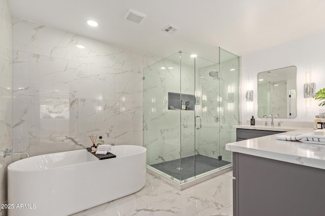 full bath with vanity, visible vents, a marble finish shower, a freestanding tub, and marble finish floor