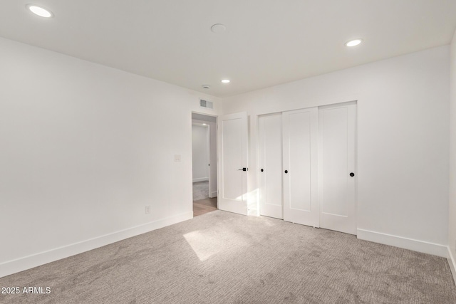 unfurnished bedroom featuring recessed lighting, visible vents, baseboards, and carpet flooring