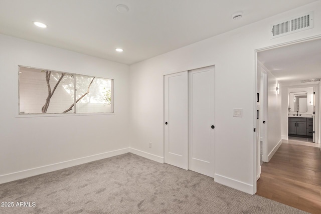 unfurnished bedroom featuring visible vents, recessed lighting, and baseboards