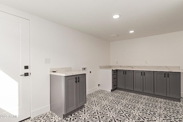 washroom with baseboards, washer hookup, recessed lighting, cabinet space, and electric dryer hookup