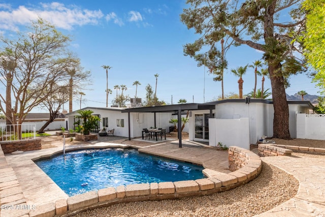 view of swimming pool featuring a fenced in pool, fence, and a patio area