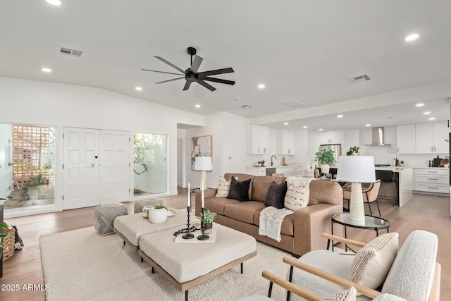 living room featuring visible vents, recessed lighting, and light wood-style floors