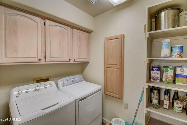laundry room featuring cabinet space and washer and clothes dryer