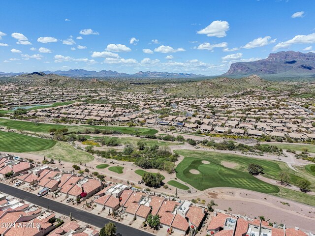 drone / aerial view with a mountain view, view of golf course, and a residential view