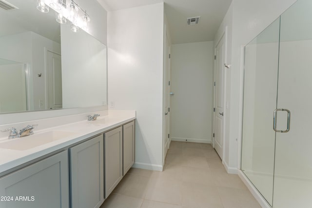 bathroom with tile patterned floors, vanity, and a shower with shower door