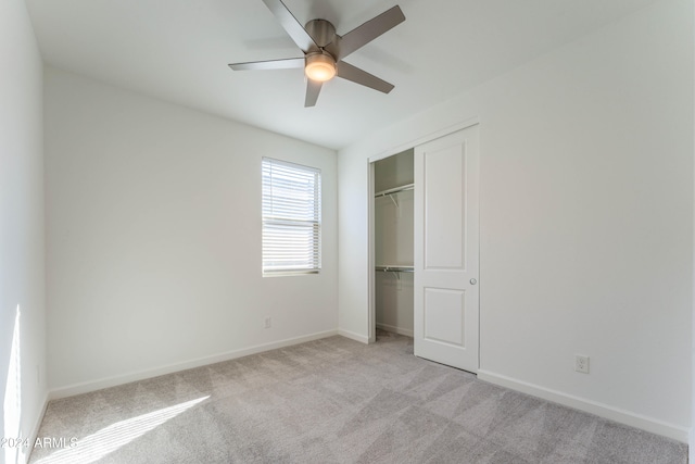 unfurnished bedroom featuring a closet, ceiling fan, and light colored carpet