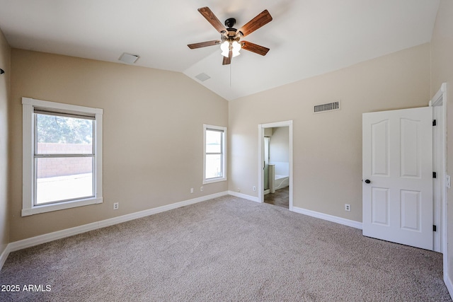 3897 E Douglas Loop, Gilbert, AZ 85234 - unfurnished bedroom featuring multiple windows, lofted ceiling, carpet, ensuite bath, and a ceiling fan