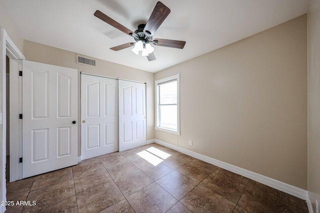 3897 E Douglas Loop, Gilbert, AZ 85234 - unfurnished bedroom featuring a closet, ceiling fan, and tile patterned flooring