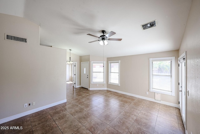 3897 E Douglas Loop, Gilbert, AZ 85234 - tiled empty room featuring plenty of natural light, a ceiling fan, vaulted ceiling, and a chandelier