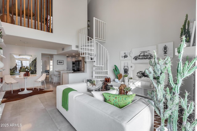 living room with concrete flooring and a high ceiling