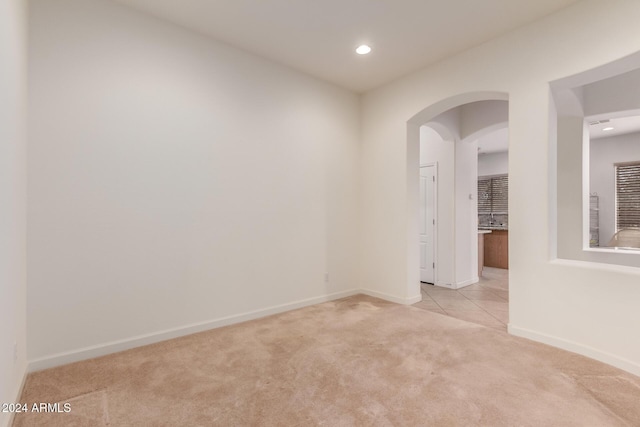 spare room featuring light colored carpet