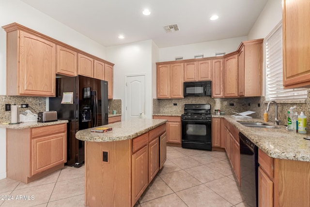 kitchen with backsplash, black appliances, sink, a kitchen island, and light stone counters